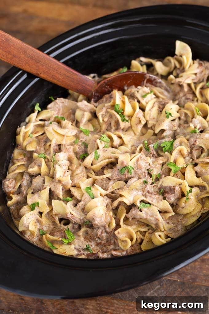 Slow Cooker Beef Stroganoff with tender beef and creamy sauce in a crock pot, ready to serve.