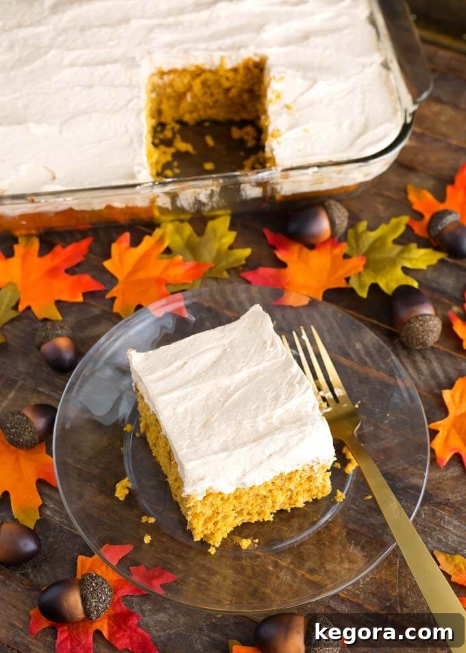 Spiced Pumpkin Cake with Cinnamon Butterscotch Frosting 4 Slice of Pumpkin Cake with Cinnamon Butterscotch Frosting on glass plate in front of rest of cake