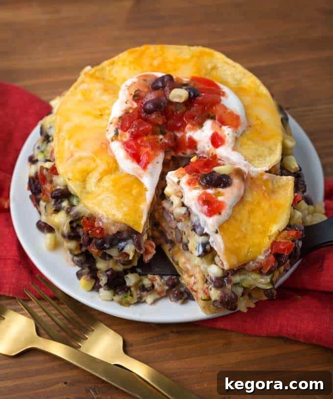 Sliced Instant Pot Veggie Tortilla Pie on a plate, showing delicious layers of vegetables, cheese, and tortillas