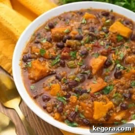 Pressure cooker Instant Pot Sweet Potato Quinoa Chicken Chili in a white bowl on yellow napkin