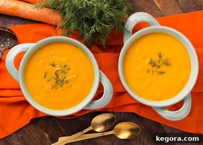 Velvety Instant Pot Carrot Puree 3 Two light blue bowls of Pressure Cooker Carrot Soup on orange background