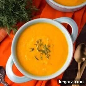 Pressure Cooker Carrot Soup in a light blue bowl on orange background