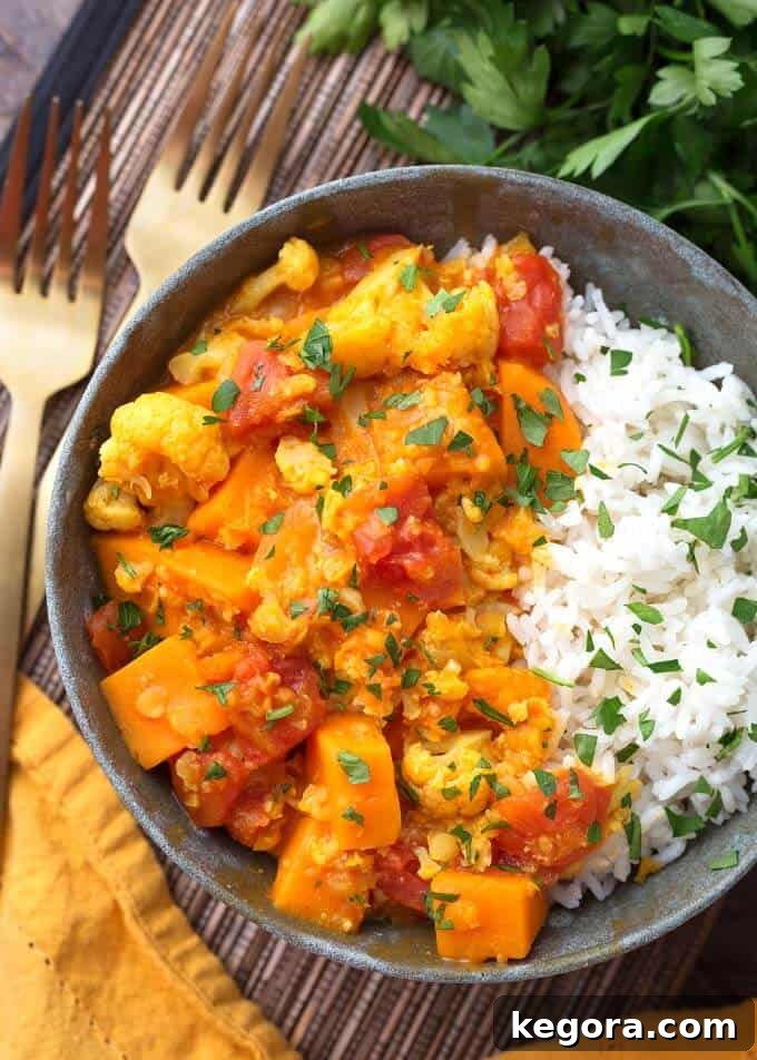 Pressure Cooker Red Curry Vegetables with rice in grey bowl