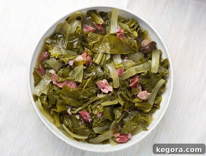 A bowl of Slow Cooker Collard Greens garnished with a sprinkle of red pepper flakes