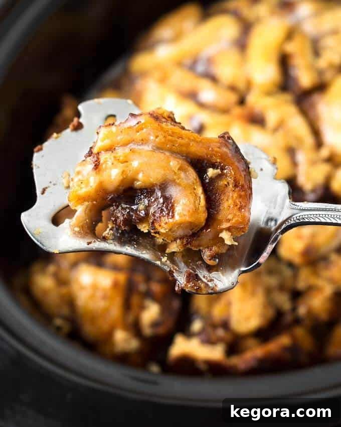 Dreamy Slow Cooker Cinnamon Roll Bake 7 Close up of spoonful of Slow Cooker Cinnamon Roll Casserole