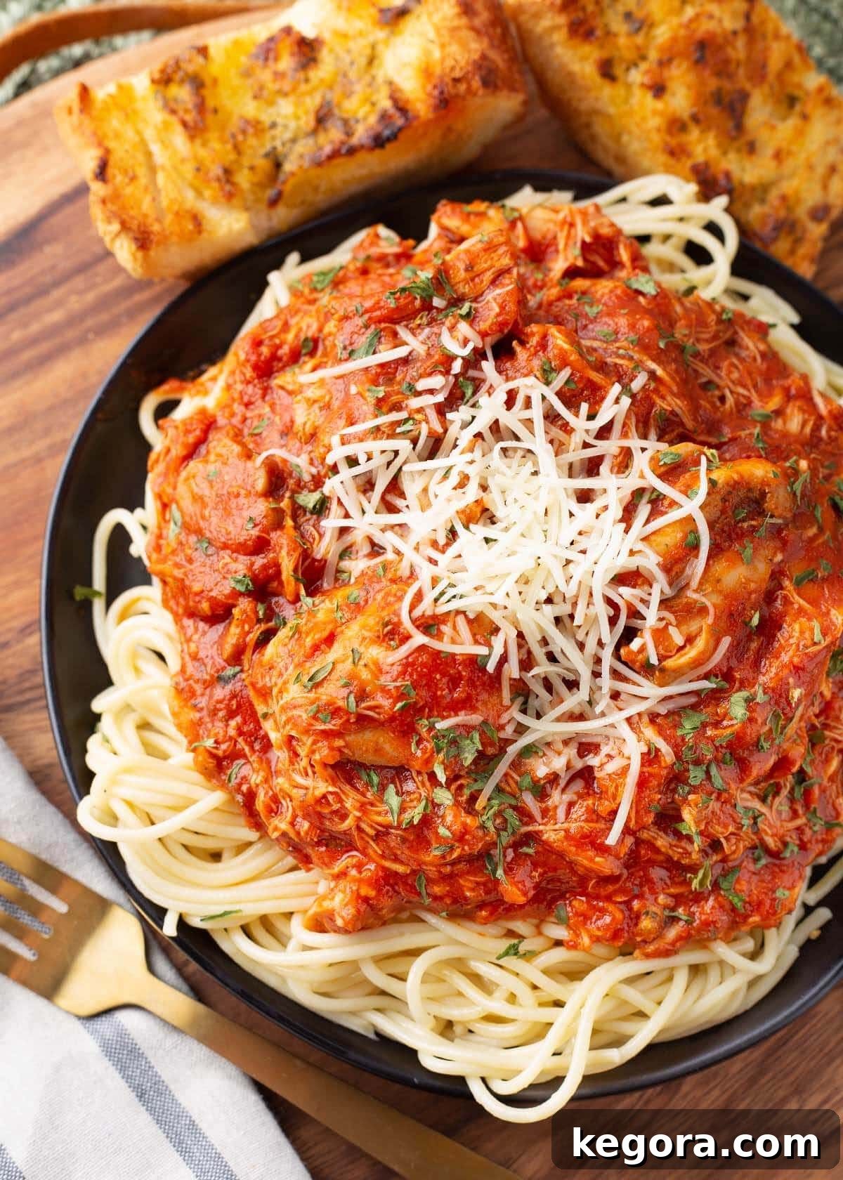 Rustic Slow Cooker Chicken Cacciatore 2 Slow Cooker Chicken Cacciatore on a black plate with noodles