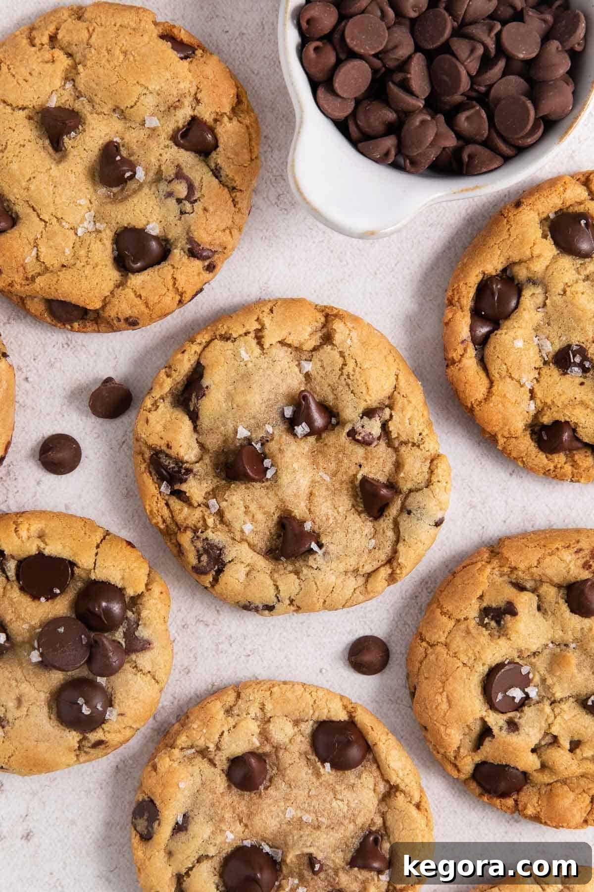 Ultimate Gluten-Free Chocolate Chip Cookies 3 Close-up shot of gluten-free chocolate chip cookies sprinkled with salt, highlighting their texture and golden color.