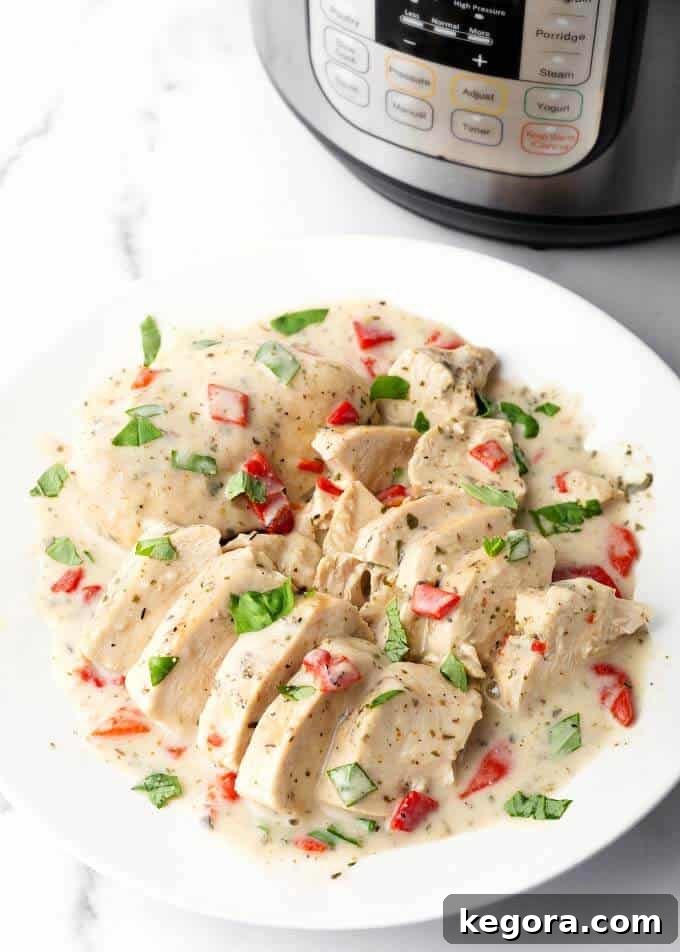 Sliced Chicken Breasts on a white plate ready to be served with creamy Italian sauce