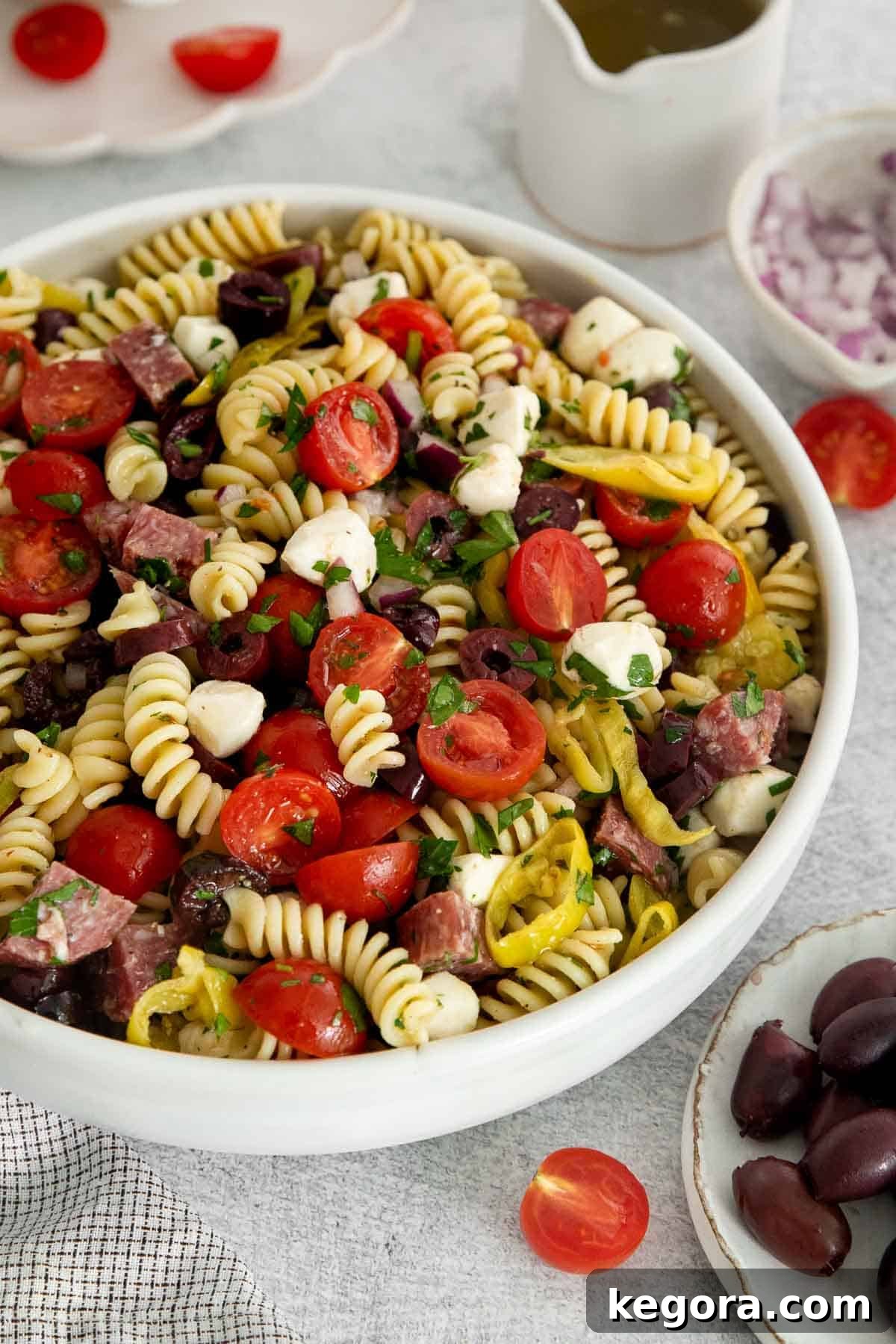 Vibrant Gluten-Free Italian Pasta Salad 8 pasta salad in a white bowl.