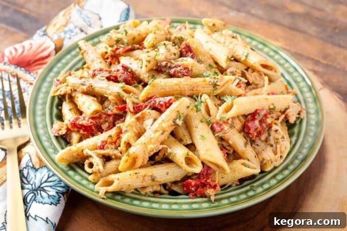 Pressure Cooker Pesto Pasta on green plate next to fork