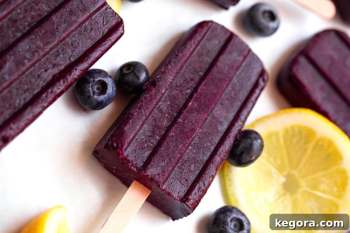 Sun-Kissed Berry Lemon Freezes 3 Blueberry Lemon Popsicles on a white background