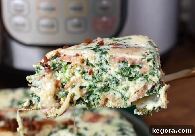 Instant Pot Savory Spinach Bacon Egg Bake 6 Close-up of a slice of Pressure Cooker Spinach Bacon Crustless Quiche on a serving utensil, ready to be enjoyed