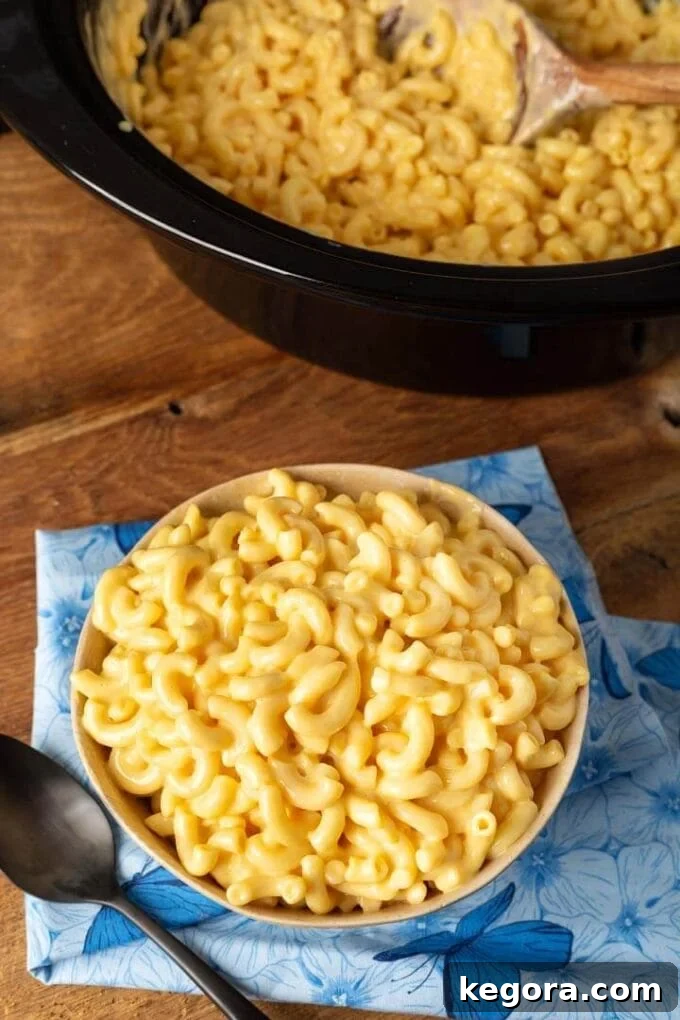 Slow-Cooked Cheesy Perfection 2 Mac and Cheese in the crock and in a bowl, ready to be served