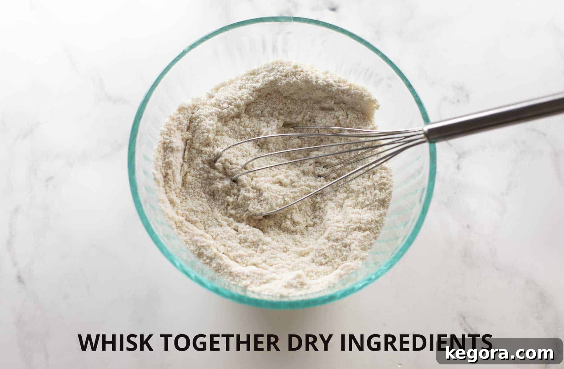 Dry ingredients for banana bread whisked together in a glass bowl