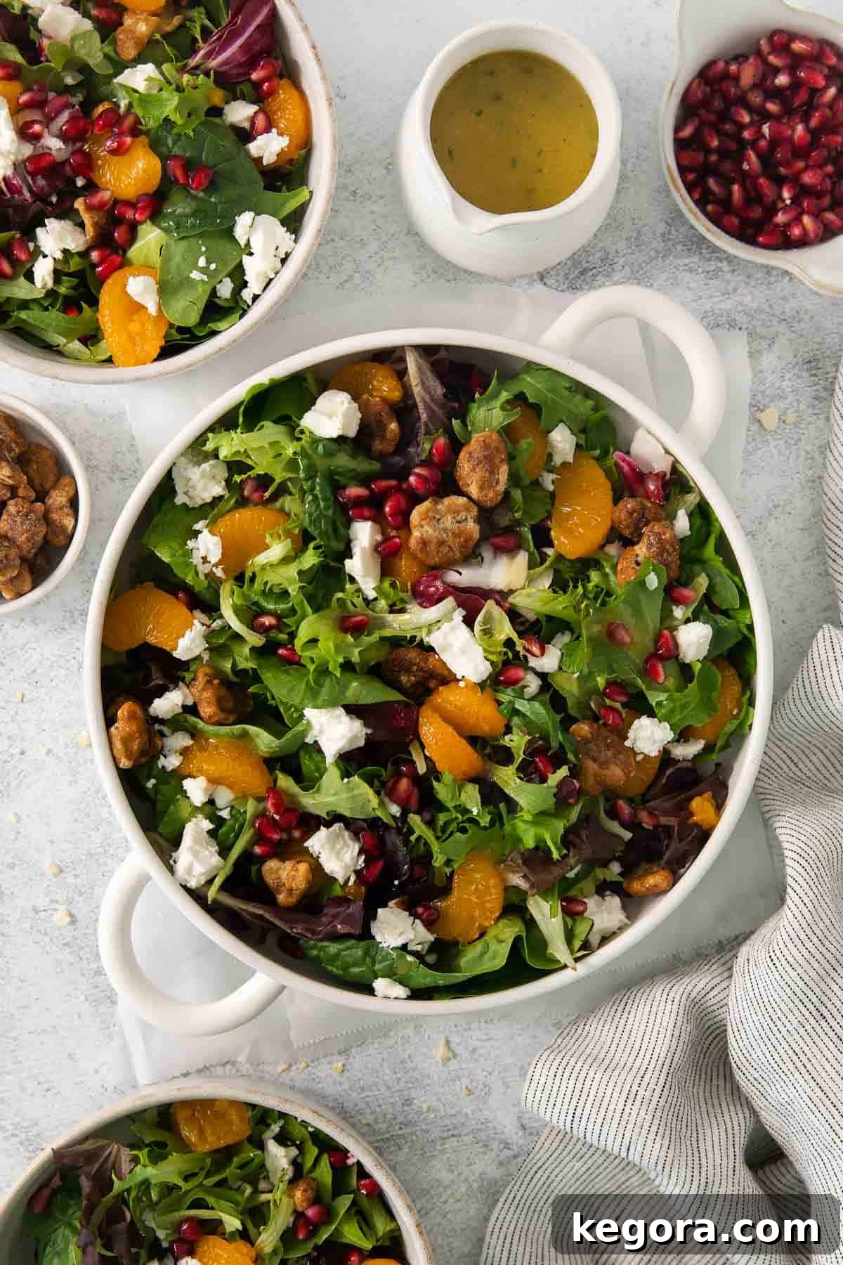 Autumn Harvest Green Salad 7 Thanksgiving green salad in a bowl on a table, surrounded by fresh ingredients