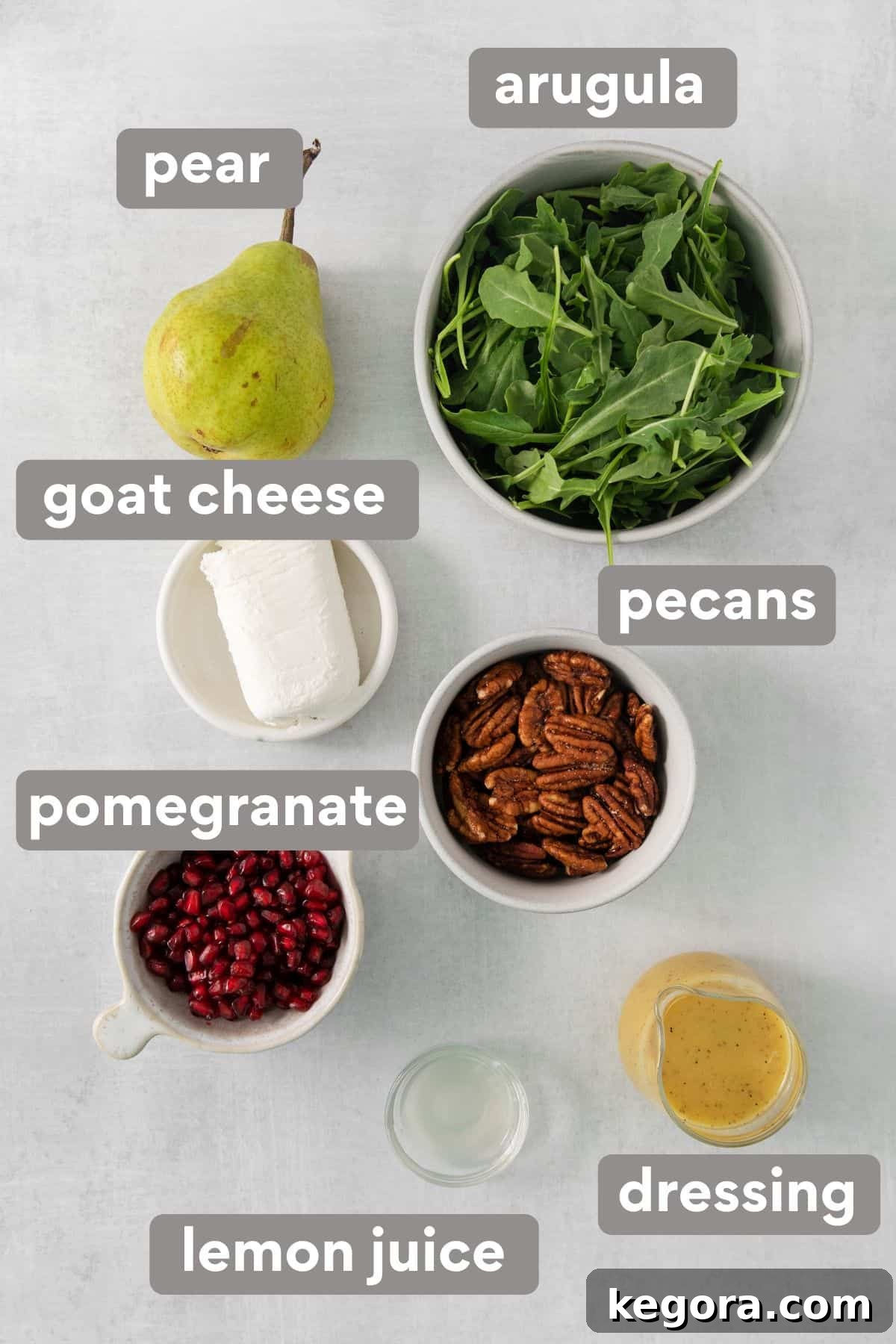 Individual ingredients for arugula pear salad laid out on a kitchen countertop
