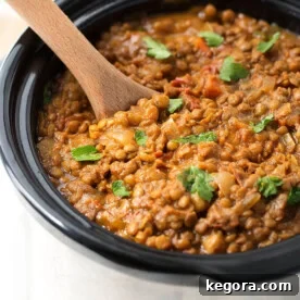 Crock Pot Curry Lentils in a crock pot with wooden serving spoon