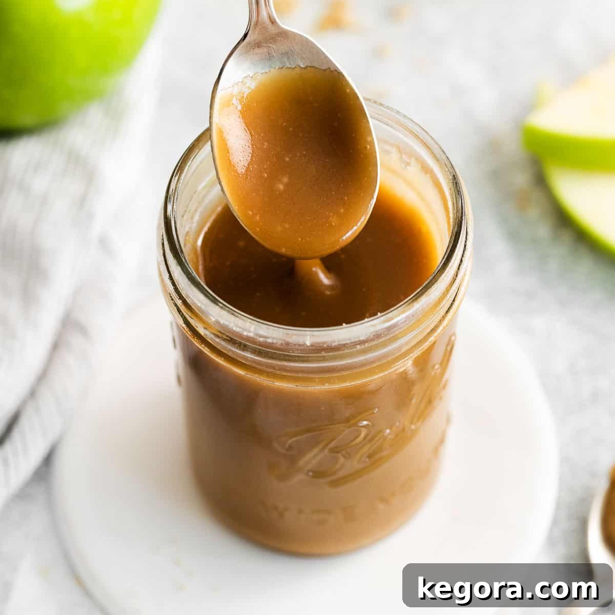 Caramel in a jar with a spoon in it