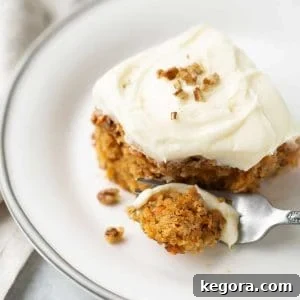 carrot cake on white plate with fork