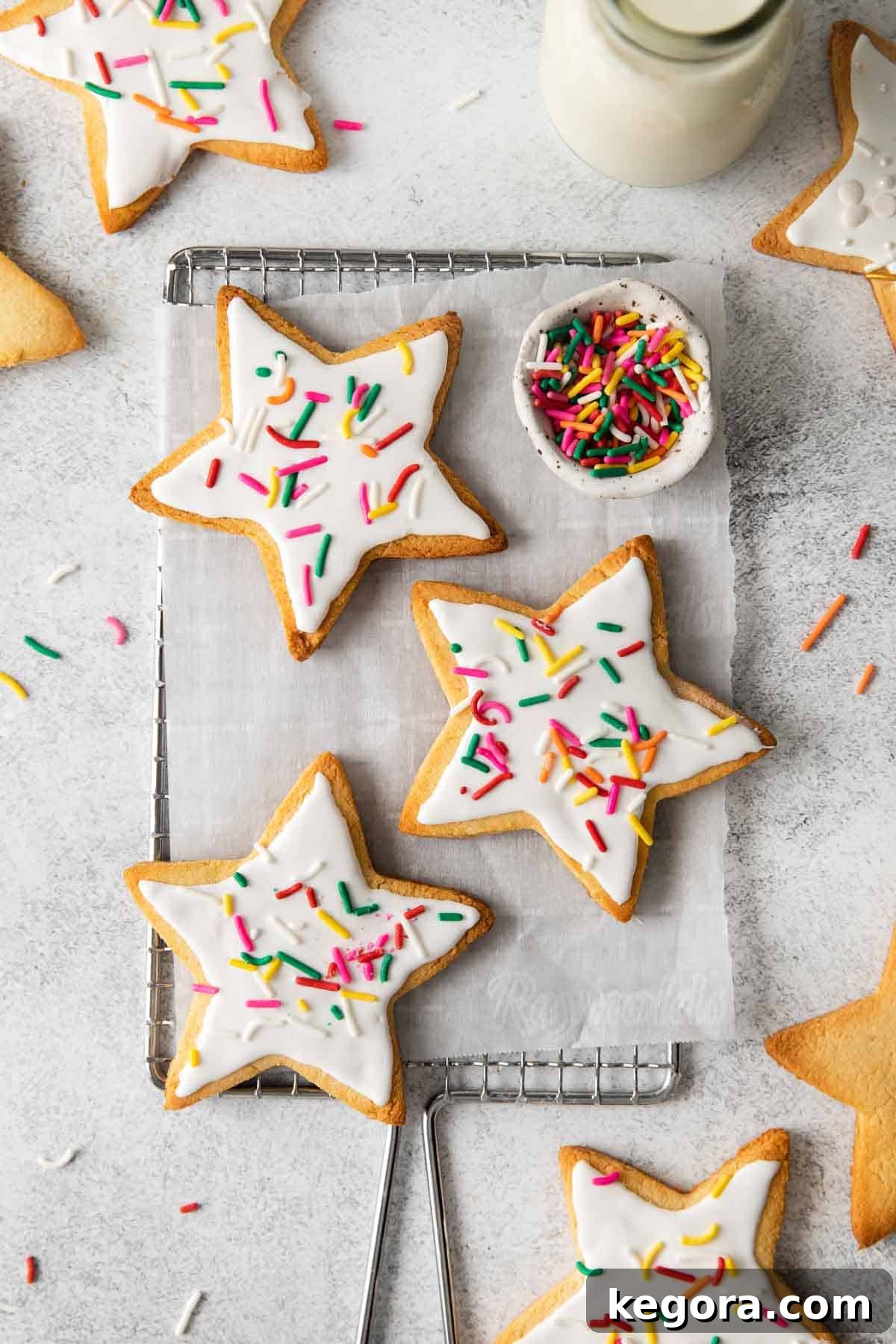 Ultimate Almond Flour Sugar Cookies 2 almond flour sugar cookies topped with white frosting and sprinkles, a modern, appealing photo