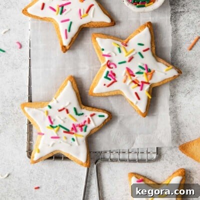 Ultimate Almond Flour Sugar Cookies 12 almond flour sugar cookies topped with white frosting and sprinkles