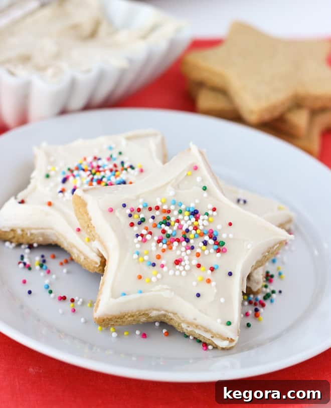 Ultimate Almond Flour Sugar Cookies 3 sugar cookies on white plate with sprinkles on pink napkin, a vintage photo from 2013