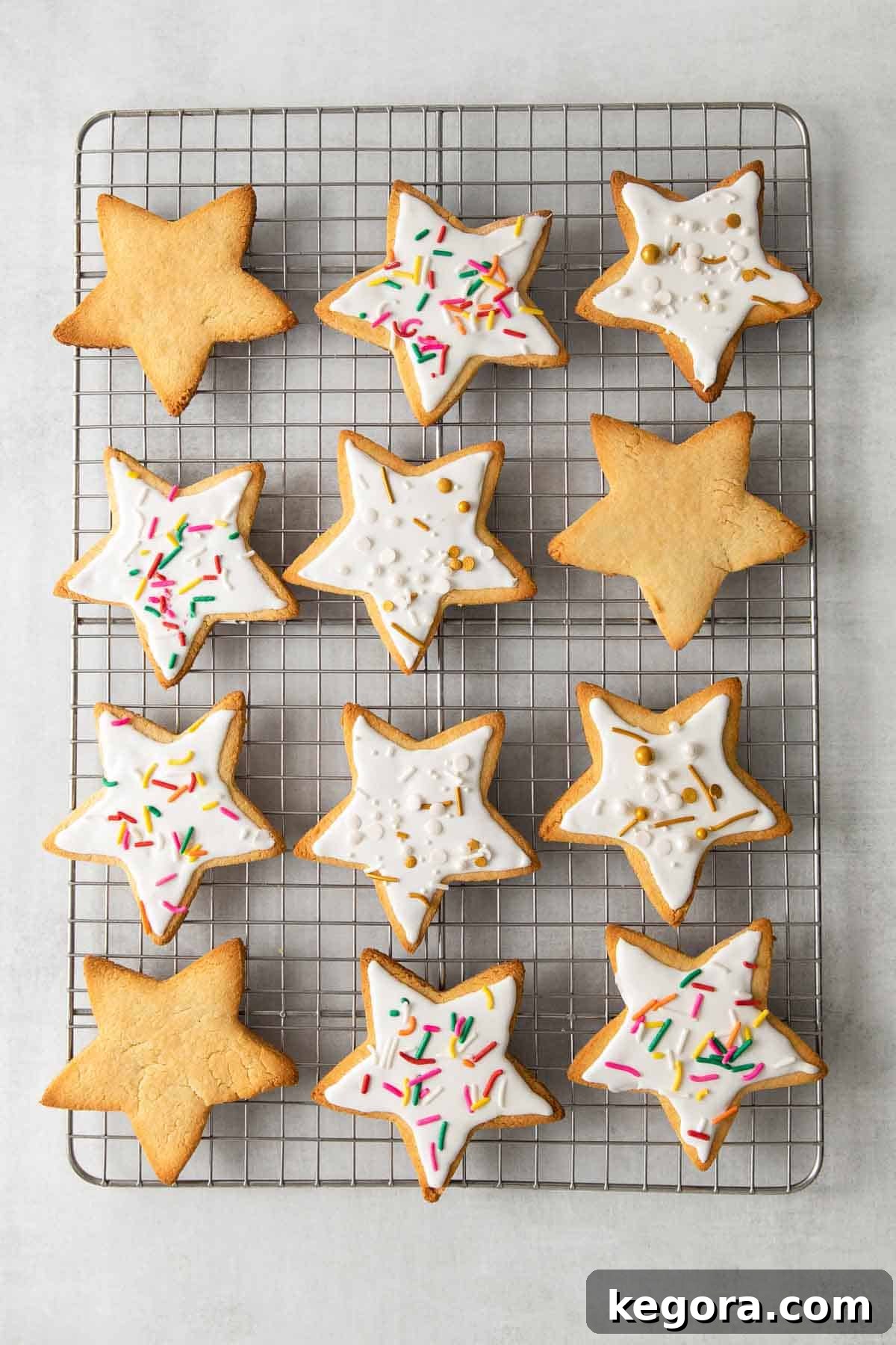Ultimate Almond Flour Sugar Cookies 8 almond flour sugar cookies on baking sheet decorated with frosting and sprinkles
