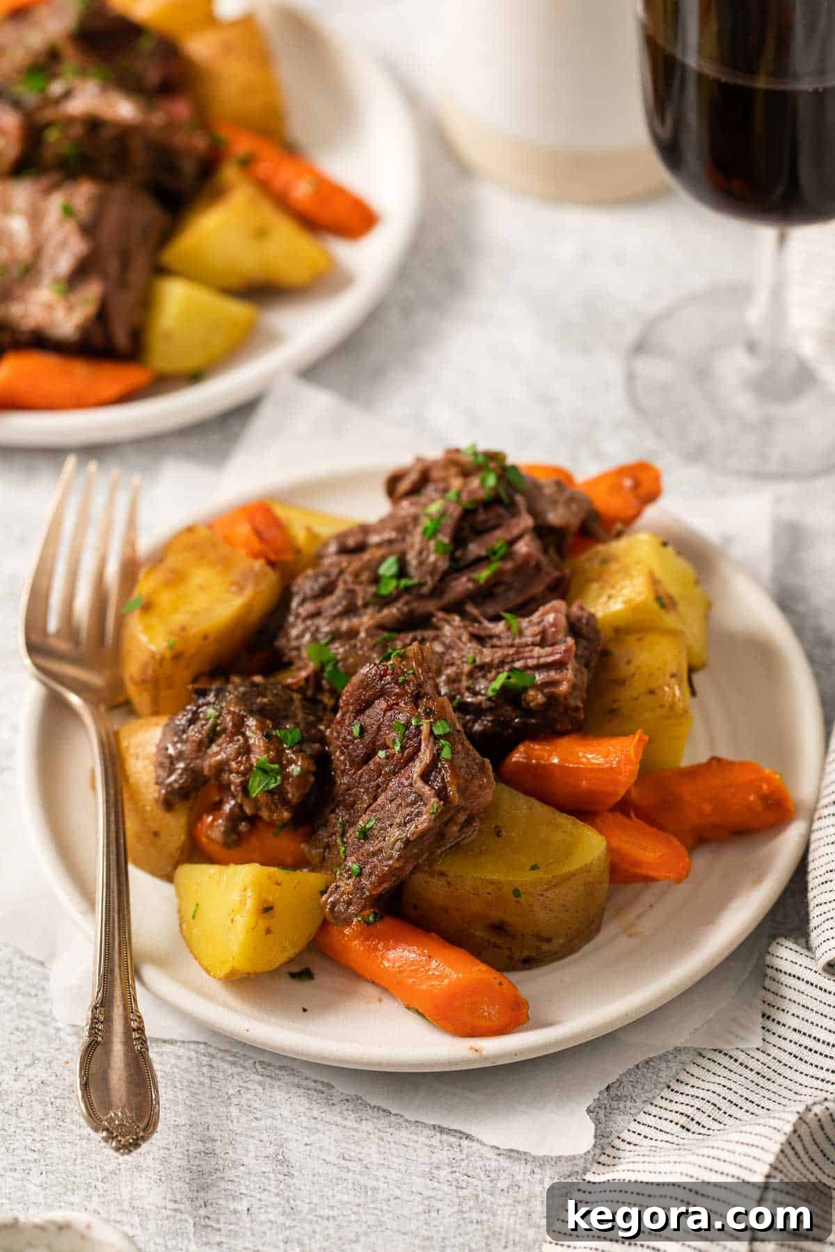 The Perfect Gluten-Free Family Pot Roast 9 A plate featuring a generous serving of gluten-free pot roast, accompanied by a fork, ready to be enjoyed