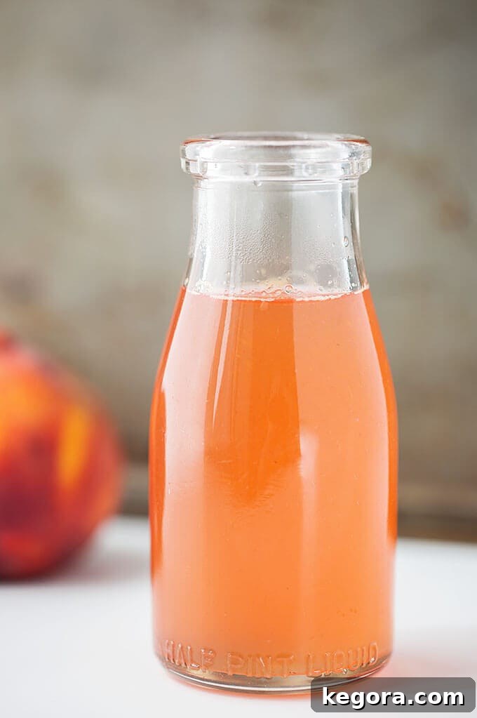 Sun Kissed Peach Syrup 2 Peach Simple Syrup in glass jar, showcasing its golden color