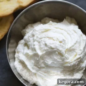 Whipped Feta Spread in a small metal bowl, showcasing its creamy texture and inviting appearance.