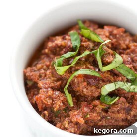 Rich, flavorful Olive Tapenade displayed in a pristine white bowl, ready to be served and savored.