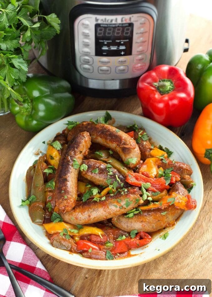 Instant Pot Sausage and Peppers on a white plate with the IP in background