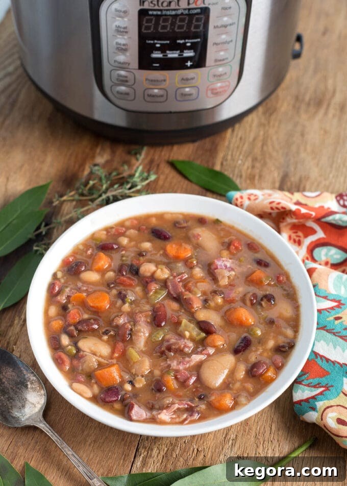 Hearty Instant Pot 15 Bean Soup 2 Instant Pot 15 Bean Soup in white bowl, Instant Pot behind it