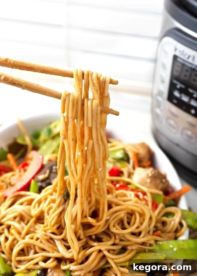 Restaurant Quality Instant Pot Lo Mein 3 Lo Mein noodles on chopsticks