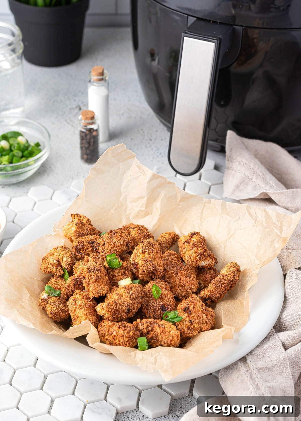 Air Fryer Popcorn Chicken served in a white bowl with dipping sauce