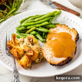 A beautifully cooked slice of Air Fryer Turkey Breast on a white plate, showcasing its tender texture.