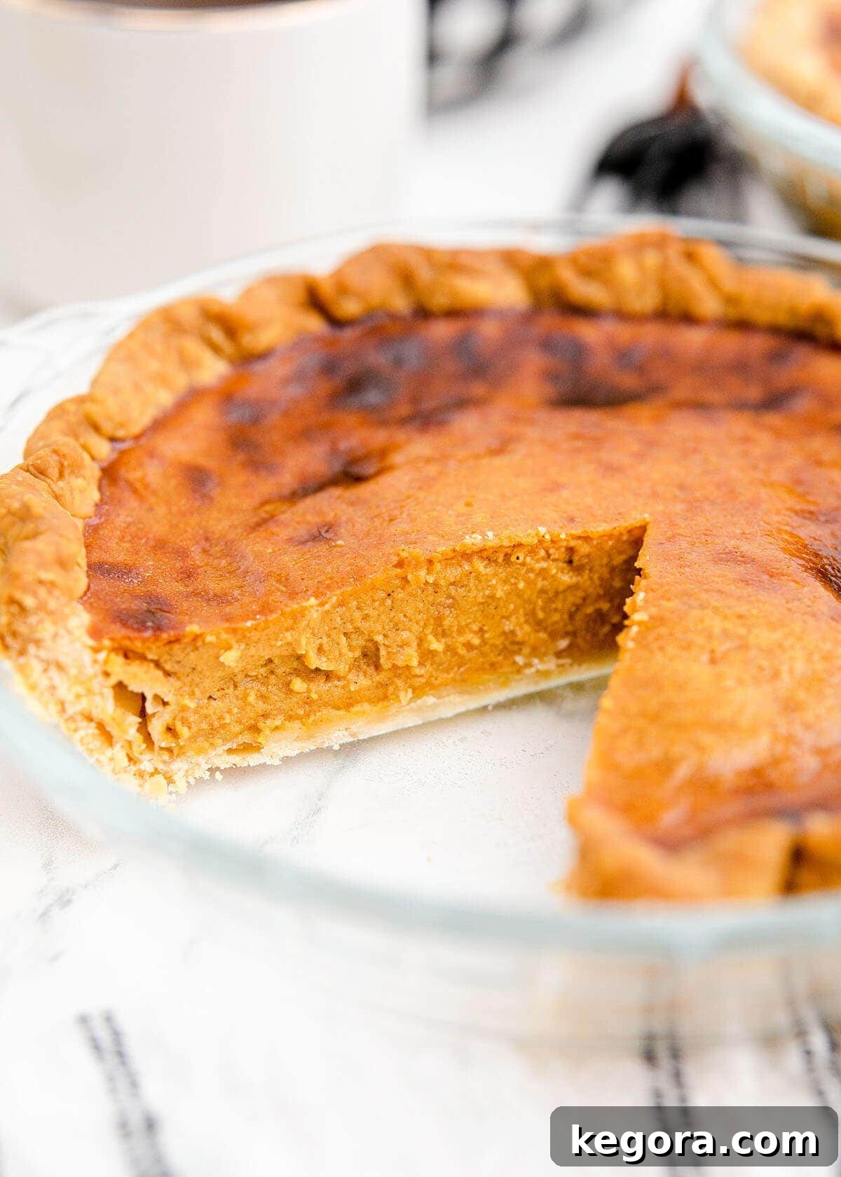 Golden Air Fryer Pumpkin Pie 3 A slice of Air Fryer Pumpkin Pie on a rustic plate, ready to be served.