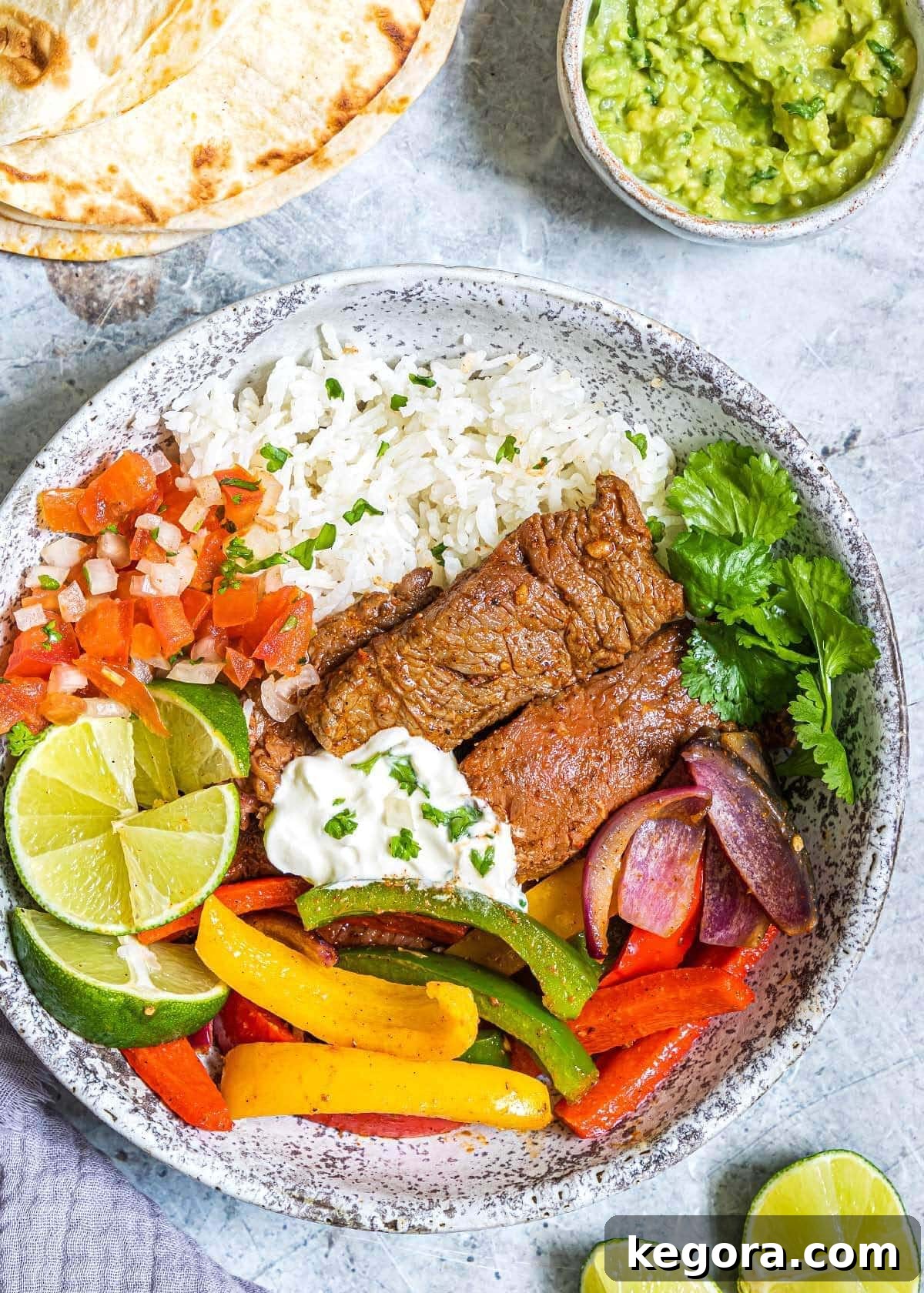 Air Fryer Steak Fajitas on a grey plate with garnishes