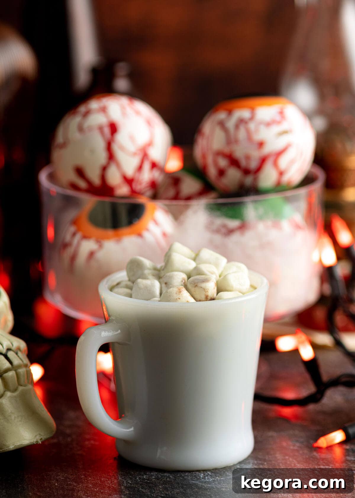 Ghoulish Gaze Hot Cocoa Bombs 2 Halloween Eyeball Hot Cocoa Bombs and cup of cocoa with marshmallows