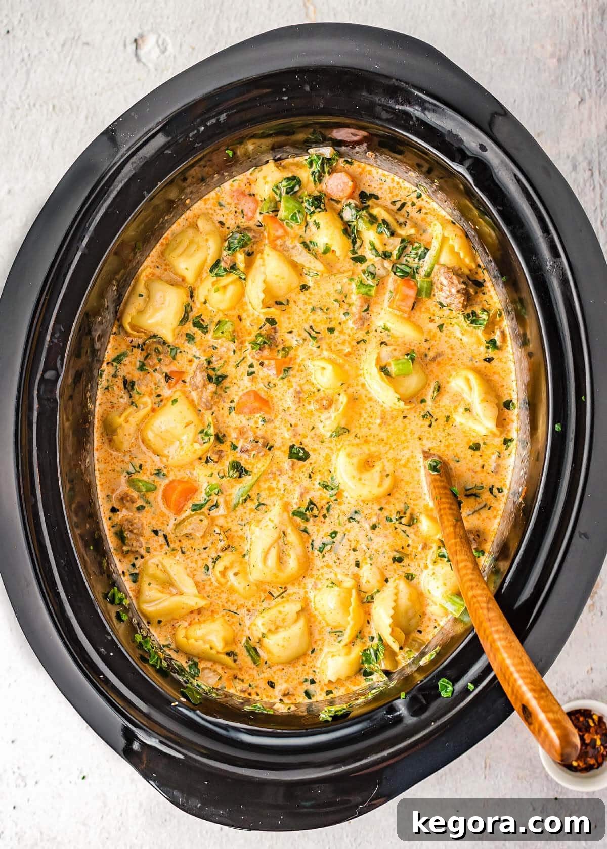 slow cooker creamy tortellini soup in black crock