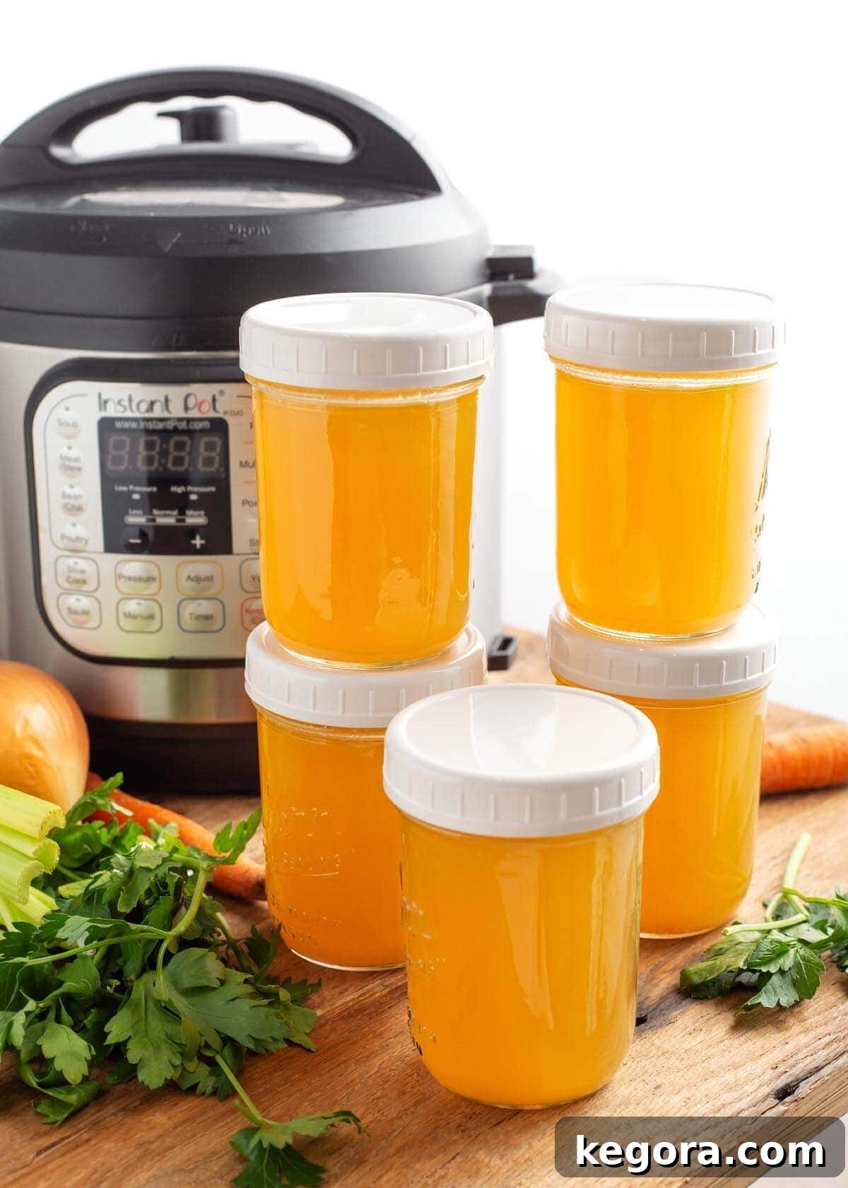 Homemade Instant Pot Chicken Broth 2 Instant Pot Chicken Broth in jars in front of IP