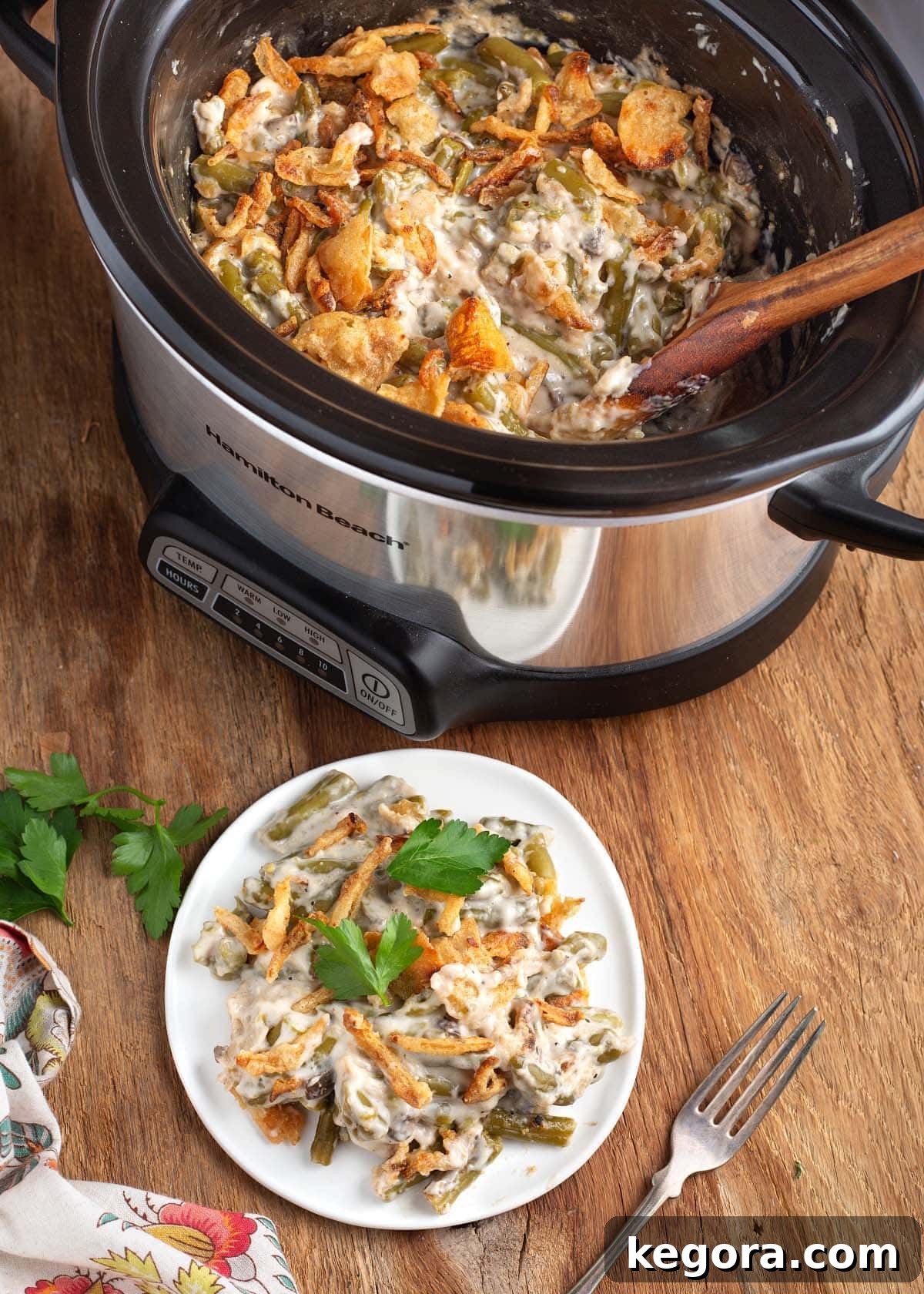 Slow Cooker Green Bean Casserole on a white plate and in the crockpot