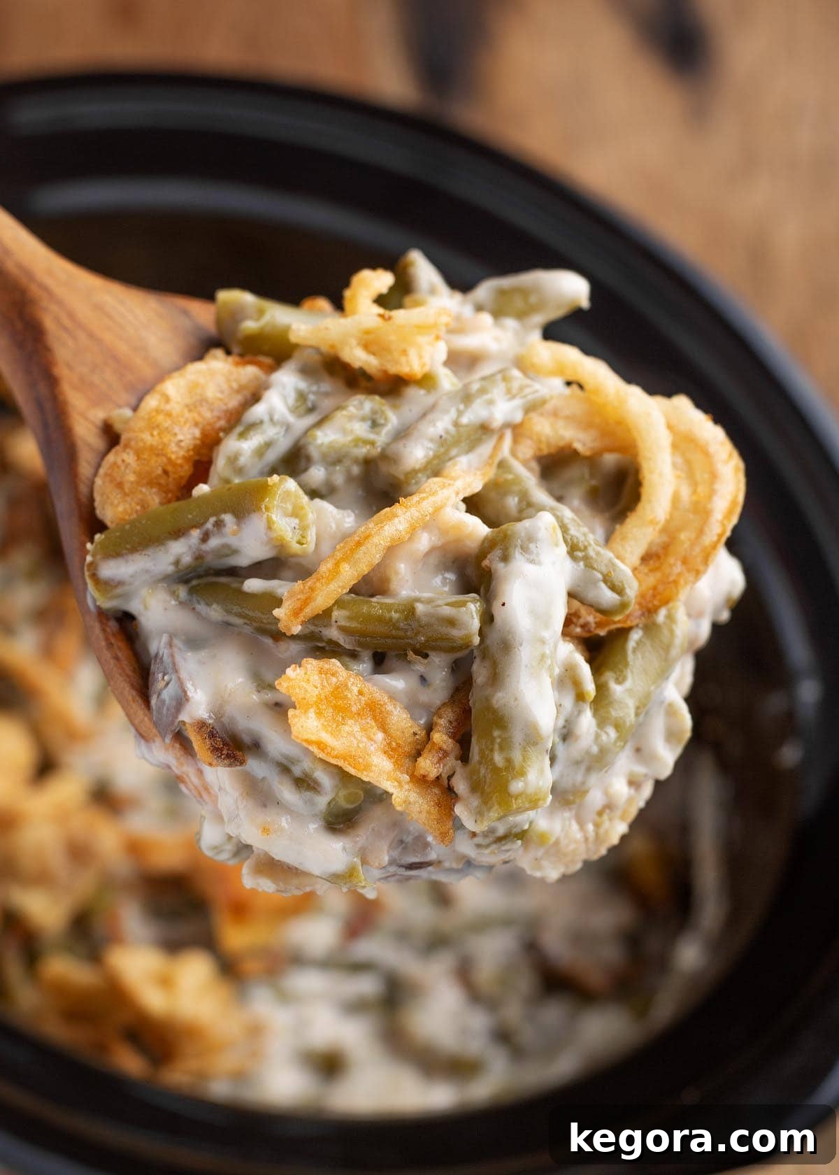 Green Bean Casserole on a wood spoon
