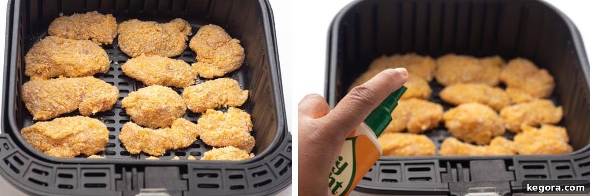 Crispy Air-Fried Nuggets 7 raw chicken nuggets in air fryer basket, spraying them with oil