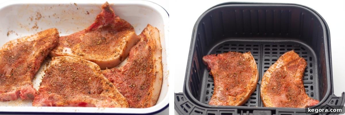 Four seasoned pork chops coated in spices, with two already placed in an air fryer basket, ready for cooking.