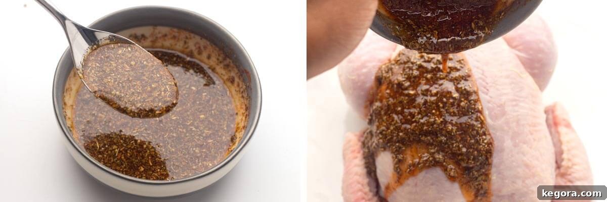Hands pouring a mixed spice rub, blended with oil, over a whole chicken, ensuring even coating.