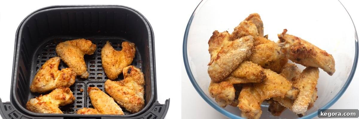 Crispy Air Fryer Buffalo Wings 8 Crispy cooked chicken wings in the air fryer basket, then transferred to a mixing bowl.
