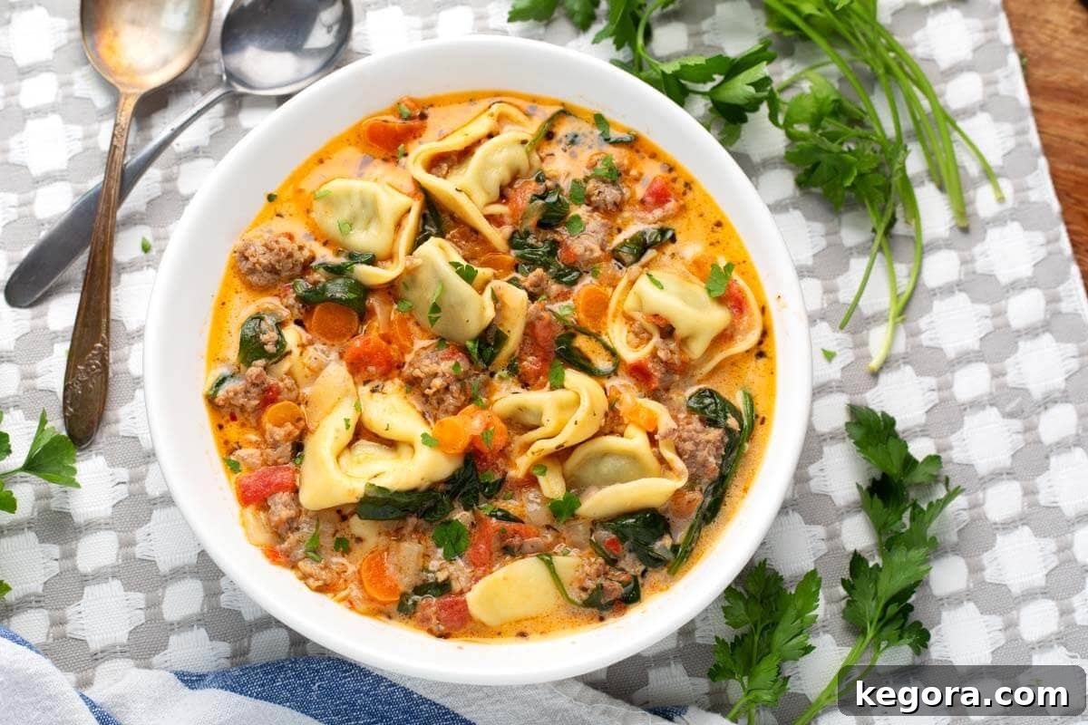 Creamy Tortellini Soup in a white bowl