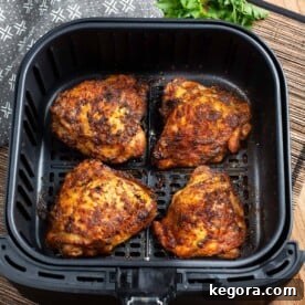 Air Fryer Chicken Thighs in air fryer basket