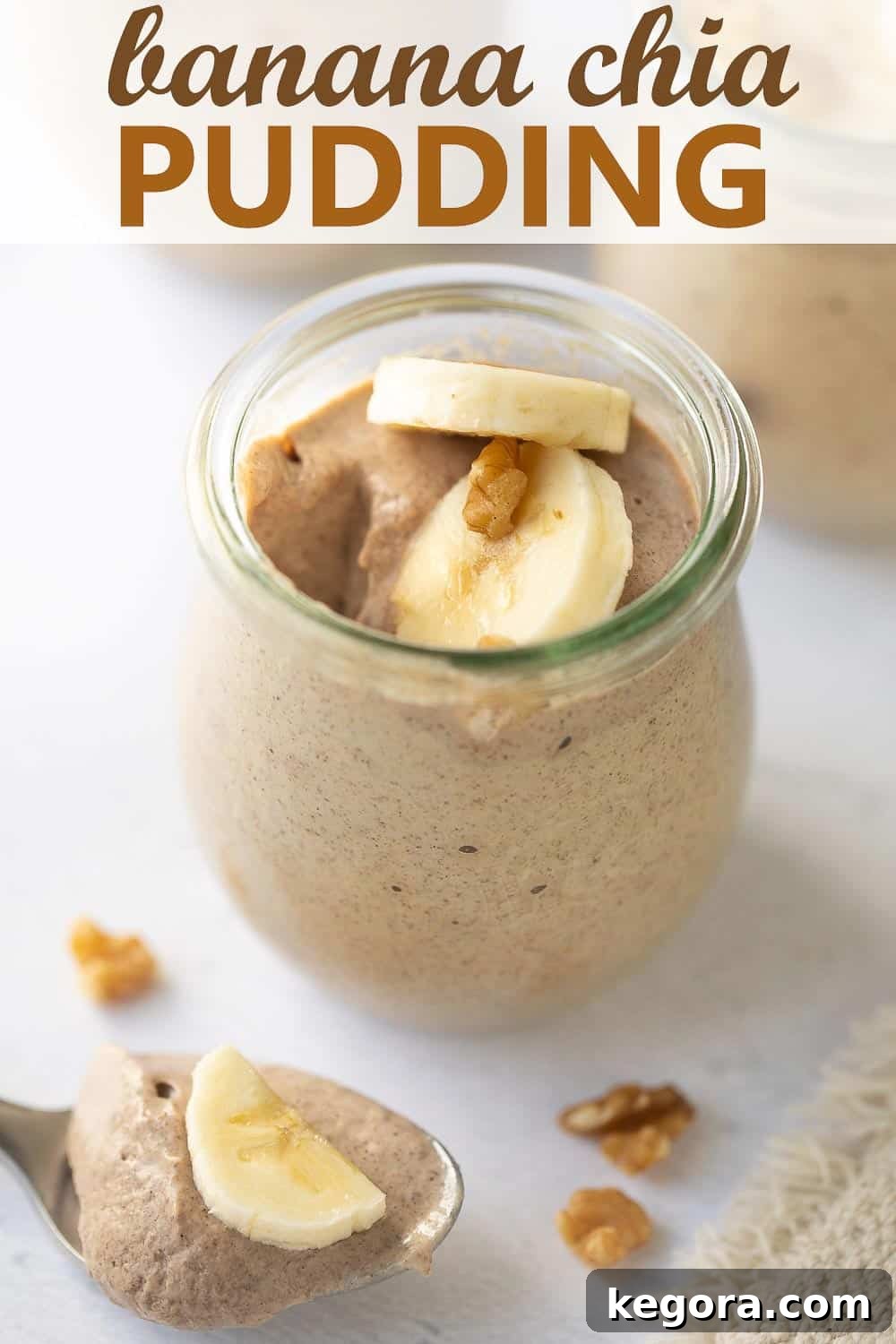Ready-to-Eat Banana Chia Pudding close up shot of a serving of banana chia pudding on a marble surface, topped with fresh banana slices